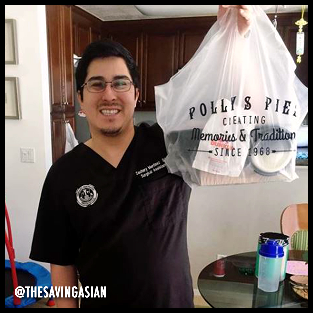 Man holding a to-go bag from Polly's Pies. Image from @thesavingasian