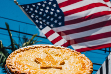 A pie with a star in the middle, with American flag in the background