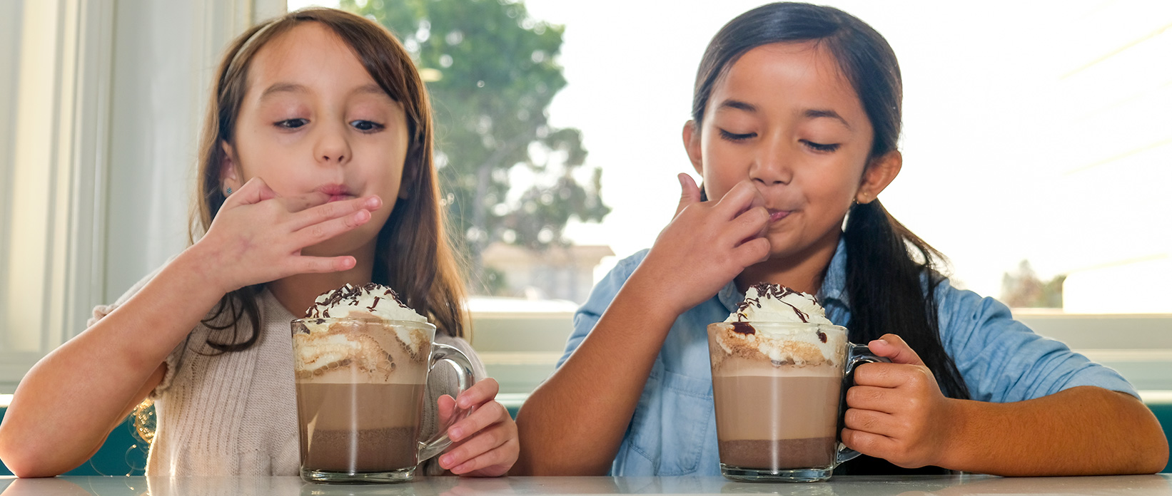 Two girls enjoying chocolate desserts